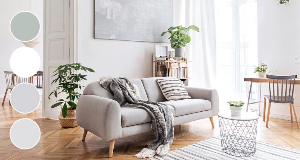 a gray couch in a living room decorated in cool neutrals